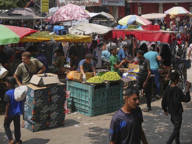 Gaza market (Abdel Kareem Hana / Associated Press) Palestinians shop at a makeshift market in Deir al-Balah, central Gaza Strip, Monday, Aug.