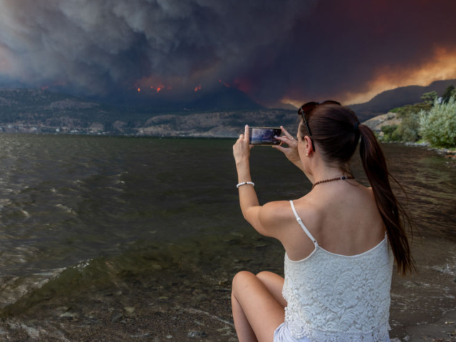 GettyImages-1607843091 Residents watch the McDougall Creek wildfire in West Kelowna, British Columbia, Canada, on