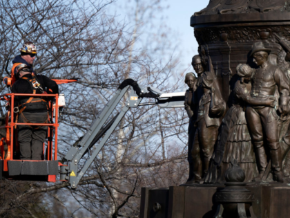 Workers dismantle the Confederate Memorial at Arlington National Cemetery December 20, 202