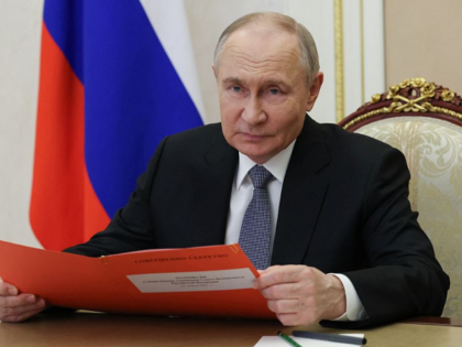 In this pool photograph distributed by the Russian state agency Sputnik, Russia's Presiden