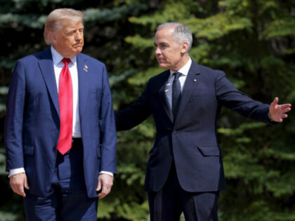 KANANASKIS, ALBERTA - JUNE 16: Canadian Prime Minister Mark Carney (R) greets U.S. Preside