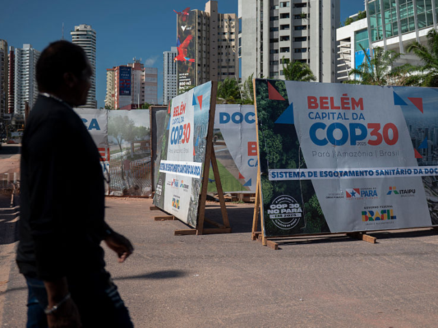 GettyImages-2221451210 A man walks past an infrastructure project underway for COP30 in Belem, Para state, Brazil