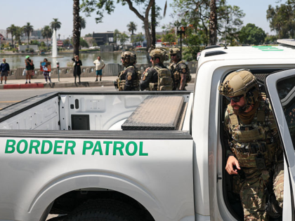 A federal agent with US Customs and Border Patrol (CBP) exits his vehicle near MacArthur P