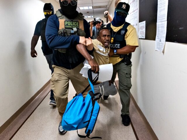 ICE Detains Immigrants Inside New York City Courthouses NEW YORK, NEW YORK - JULY 24: Federal agents, including members of ICE, drag a man away af