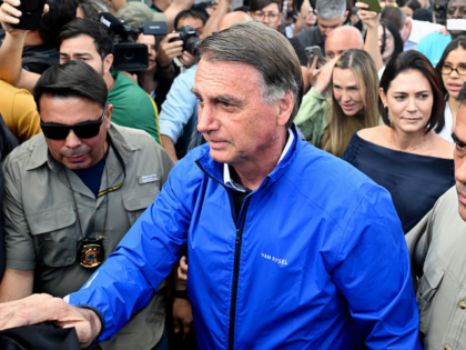 Former Brazilian President Jair Bolsonaro and his wife Michelle Bolsonaro (R) attend a mee