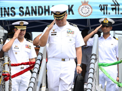 A Philippine navy officer (C) disembarks while officers of the Indian Navy survey vessel I