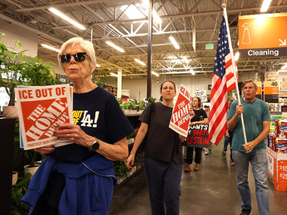 PASADENA, CA  - AUGUST 6, 2025 - - Anit-ICE activists march through the Home Depot in Pa