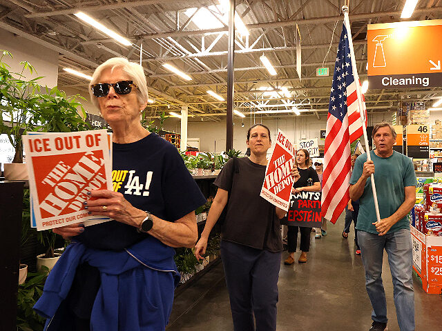 PASADENA, CA  - AUGUST 6, 2025 - - Anit-ICE activists march through the Home Depot in Pa