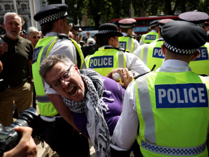 A protester is carried away by police officers at a "Lift The Ban" demonstration in suppor