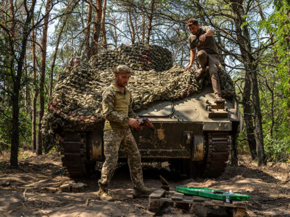 KHERSON, UKRAINE - AUGUST 8: Ukrainian soldiers service their tanks and armored vehicles i