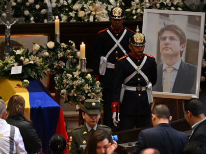 People pay homage to slain Colombian presidential candidate Miguel Uribe as his body lies