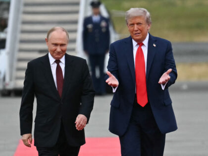 US President Donald Trump greets Russian President Vladimir Putin on the tarmac after they