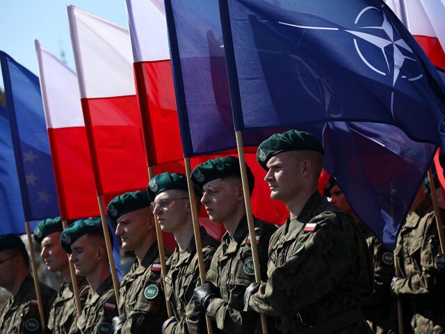 Polish Armed Forces Day Celebrations In Warsaw In Warsaw, Poland, on August 15, 2025, Polish Army soldiers carry the Polish and NATO flag