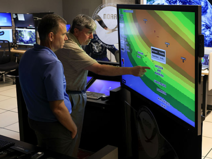 MIAMI, FLORIDA - AUGUST 13: (L-R) Jamie Rhome, Deputy Director of the National Hurricane C
