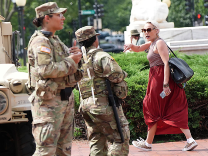 WASHINGTON, DC - AUGUST 14: A person yells in protest at members of the National Guard as