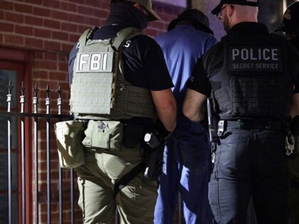 WASHINGTON, DC - AUGUST 14: Federal agents arrest a man outside New York Avenue Presbyteri