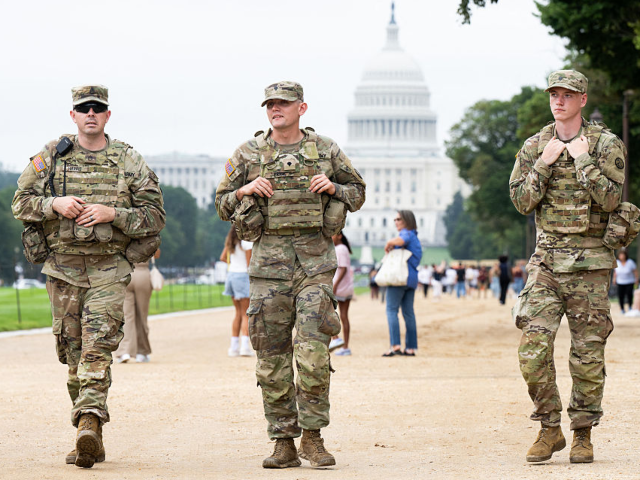 GettyImages-2230417614 Members of the National Guard patrol near the US Capitol on the National Mall near the US