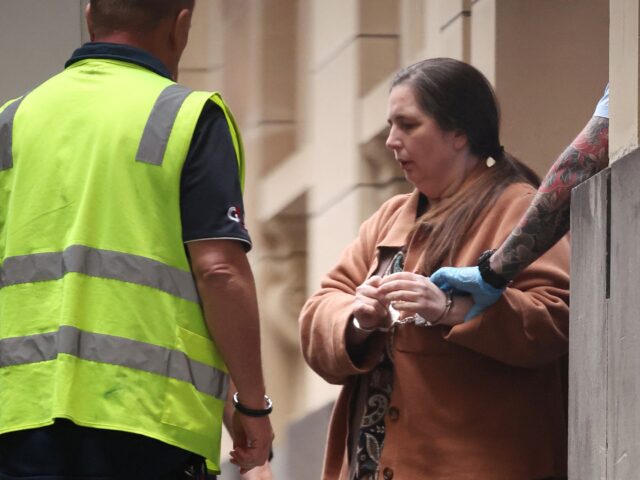 Convicted murderer Erin Patterson is escorted out of the Supreme Court of Victoria followi
