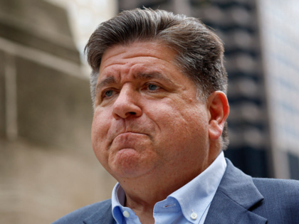 Illinois Governor JB Pritzker walks to speak at a press conference in Chicago, Illinois, o