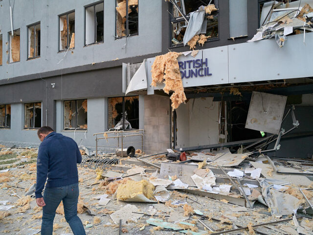 Bombardment In Kyiv Leaves At Least Eight Dead KYIV, UKRAINE - AUGUST 28: A resident walks past the British Council after a Russian balli