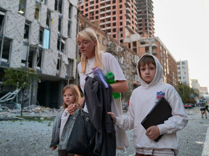 KYIV, UKRAINE - AUGUST 28: Residents flee a residential area after a Russian ballistic mis