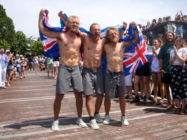 Scottish brothers (L-R) Lachlan, Jamie and Ewan MacLean celebrate as they arrive into Cair