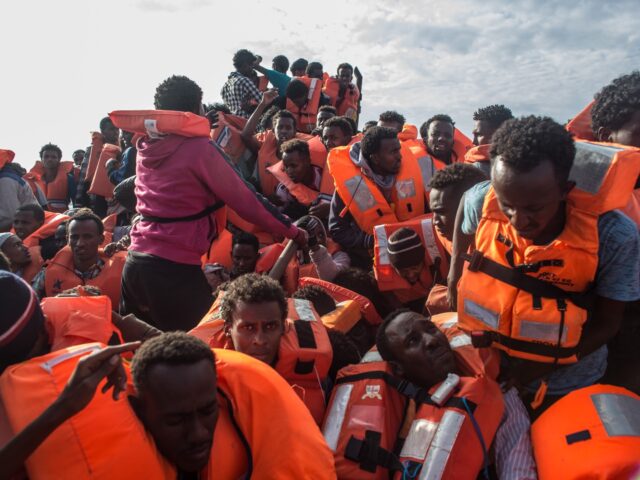 LAMPEDUSA, ITALY - MAY 24: Refugees and migrants put on life jackets distributed by rescue