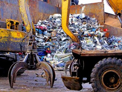 The claws of a scrap handler machine prepares to move piles of scrap metal at General Iron
