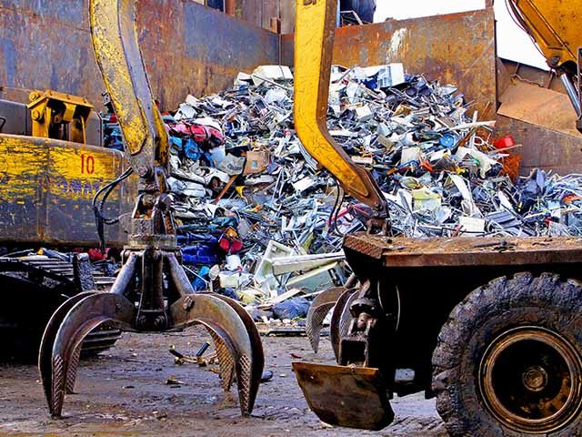 GettyImages109699697 The claws of a scrap handler machine prepares to move piles of scrap metal at General Iron