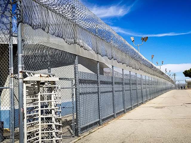 GettyImages1203493838 Prison fences and turnstile of Mira Loma Detention Center in Lancaster California.