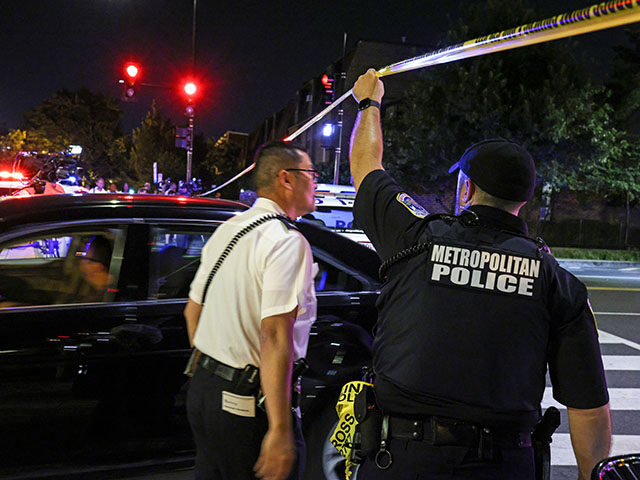 GettyImages1330139596 A police officer holds up caution tape near the site of a shooting on July 22, 2021 in Was