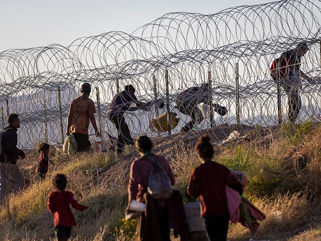 GettyImages1488575554 Immigrants cross into the United States from Mexico hoping to be processed by U.S. border