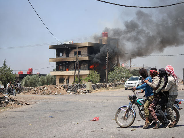 Tribal and bedouin fighters cross Walga town as they mobilise amid clashes with Druze gunm