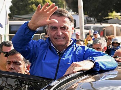 Former Brazilian President Jair Bolsonaro waves to supporters during a meeting with motorc