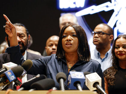 Texas Representative Jasmine Crockett speaks in front of Democratic members of Congress an