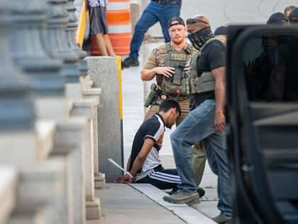 ICE and other federal agents take a delivery driver into custody at Union Station on Augus