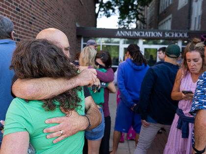 Parents await news during an active shooter situation at the Annunciation Church in Minnea