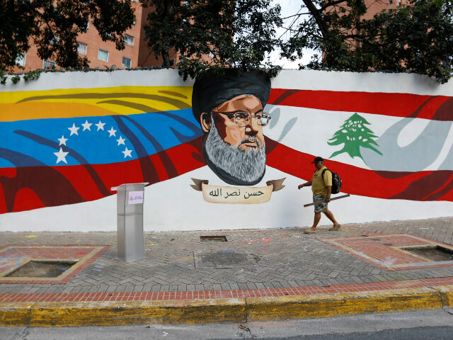 Hezbollah in Venezuela A man walks by a mural painted by the "Somos Venezuela" Movement depicting the L