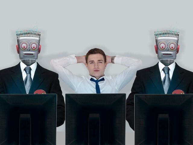Human worker idle between two AI-powered robots
