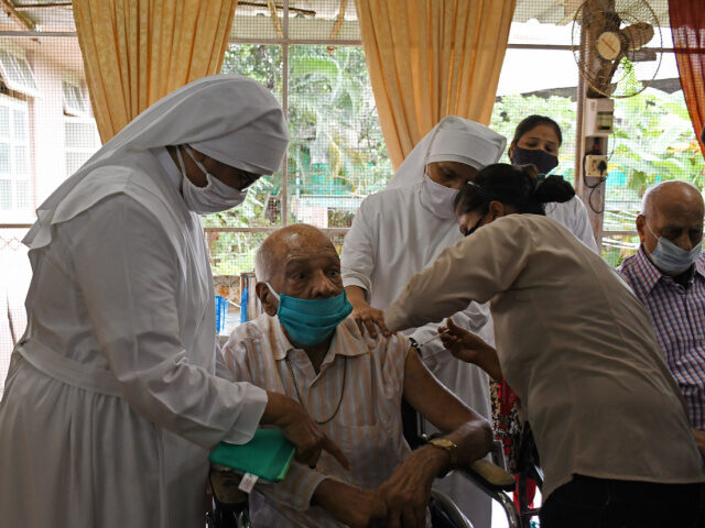 Little Sisters Take Care of Elderly An elderly man wearing a facemask as a precaution against the spread of covid-19 is being