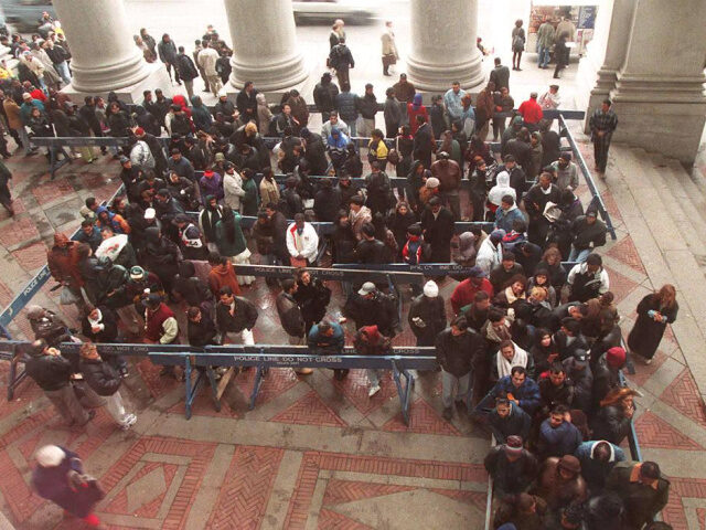 Over 200 couples gather behind barricades outside the Municipal Building as they wait to g