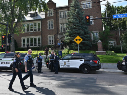 Police and first responders work at the scene of a shooting near Annunciation Church and C