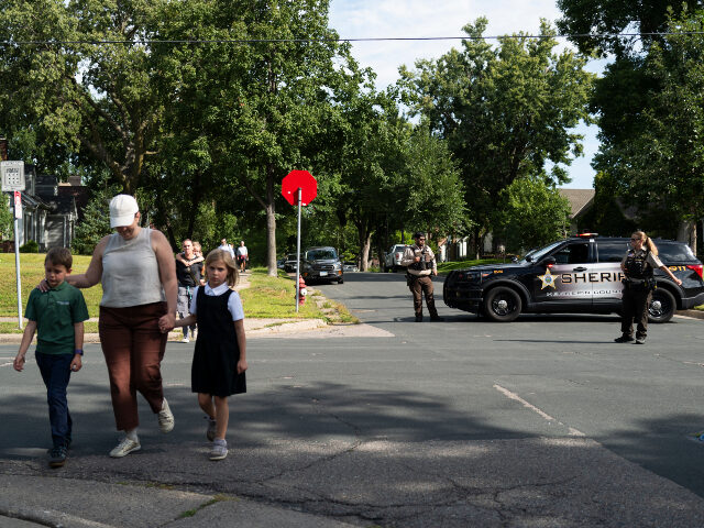 Minneapolis shooting Families walk with their children following a mass shooting at Annunciation Catholic Schoo
