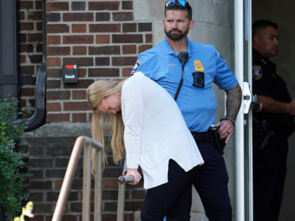 A person walks out of the Annunciation Church's school as police respond to a reporte