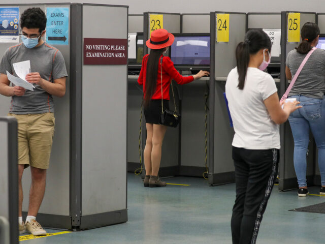 Clients observe social distancing while giving written driving test at DMV on Thursday, Au