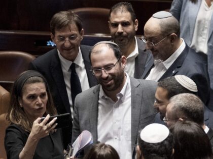 Israeli lawmaker Simcha Rothman, center, celebrates with colleagues after approving a key