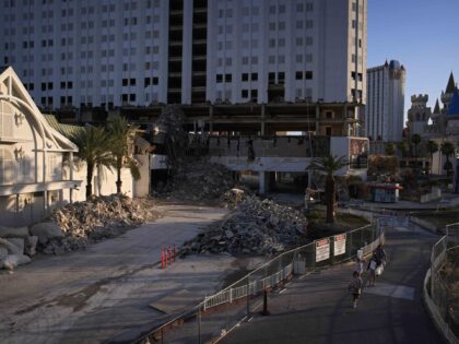 People walk near a partially demolished Tropicana hotel-casino Wednesday, May 22, 2024, in