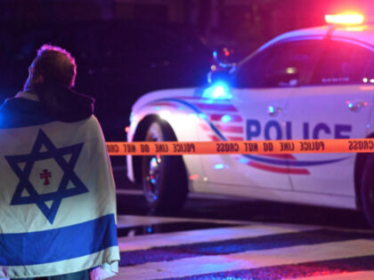 FBI agents work at the crime scene where two Israeli Embassy Staff Members were killed as