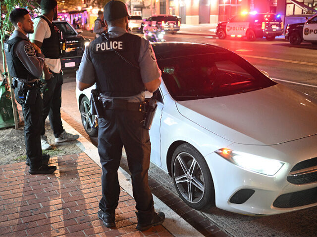 Transit Police stand next to a stopped vehicle on U Street in Washington, DC on August 16,