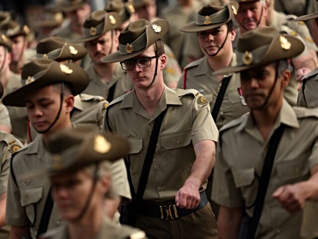 Servicemen and women march to the Shrine of Remembrance to honour soldiers who have died i